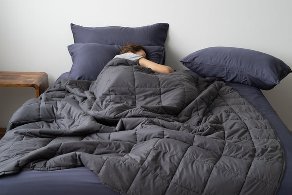 Woman using Weavve's weighted blanket smooth fabric