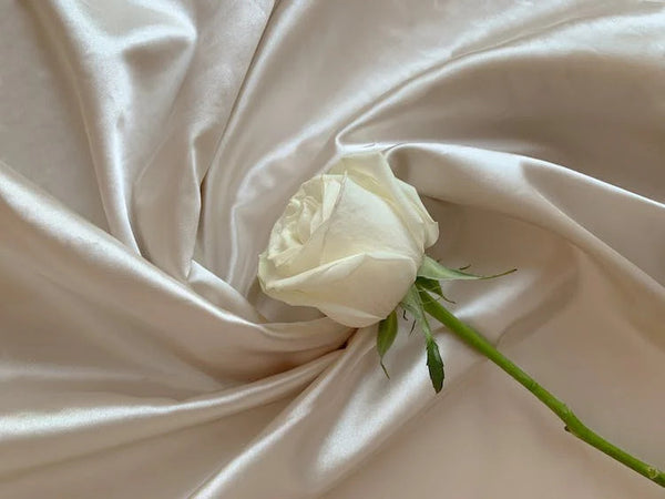 White rose on white silk textile