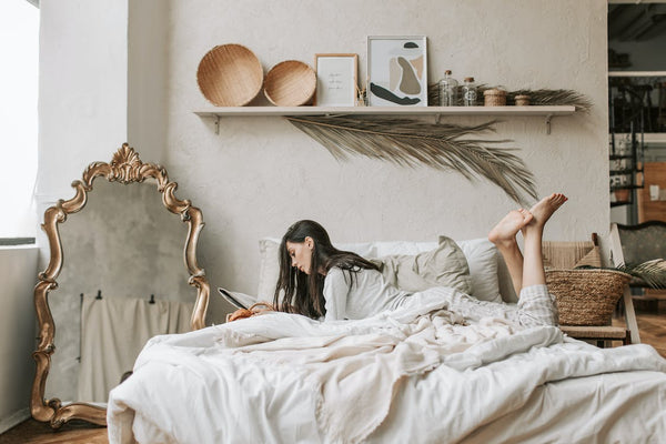 Woman lying on her bed with blanket 