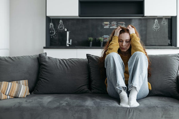 Woman with anxiety sitting on a couch