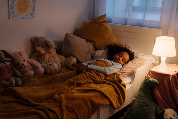 child sleeping on bed