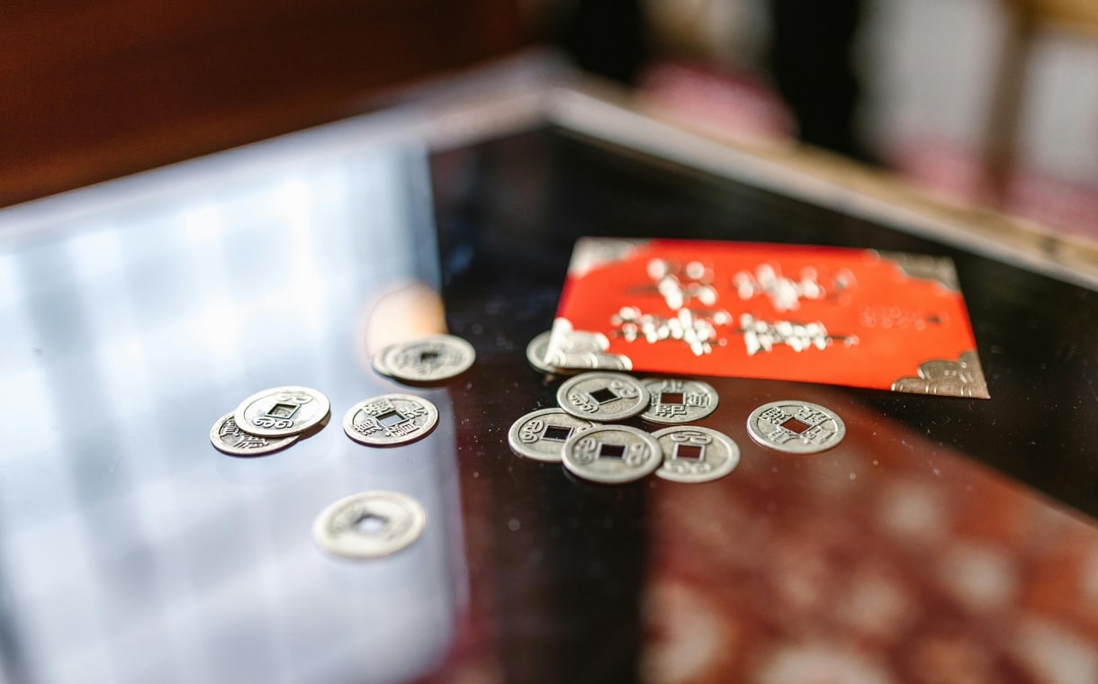 coins beside a red envelope