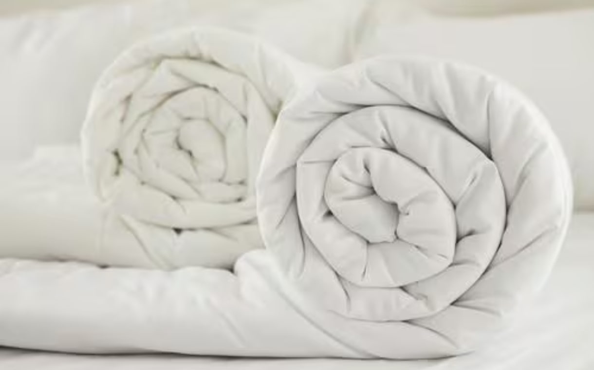 rolled white comforters