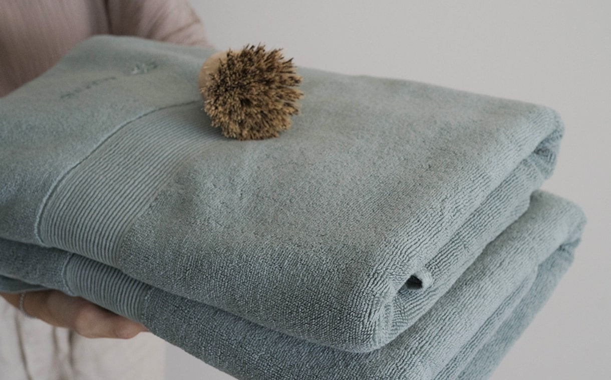 woman holding folded cotton towels