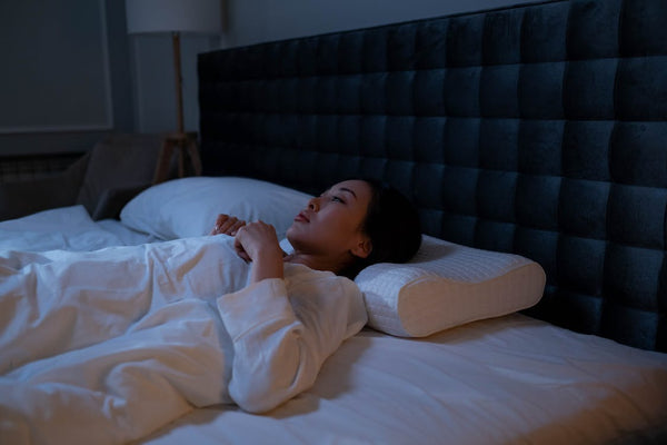 woman in white pajama lying on pillow