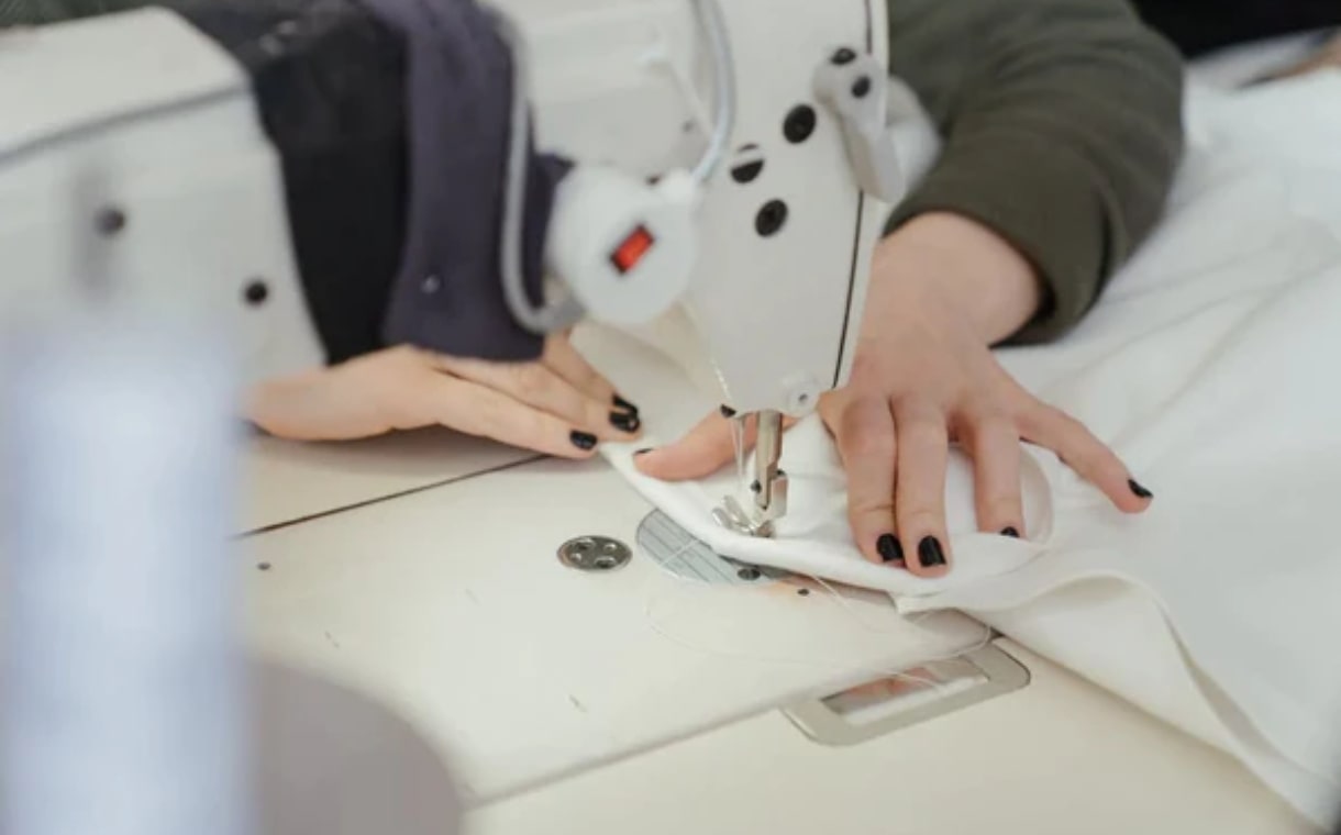 woman sewing bedlinen on a sewing machine