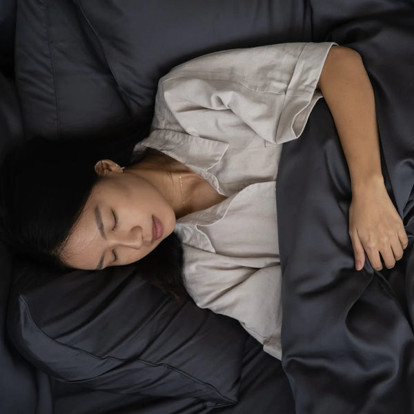 woman sleeping on signature TENCEL™ classic set in slate grey