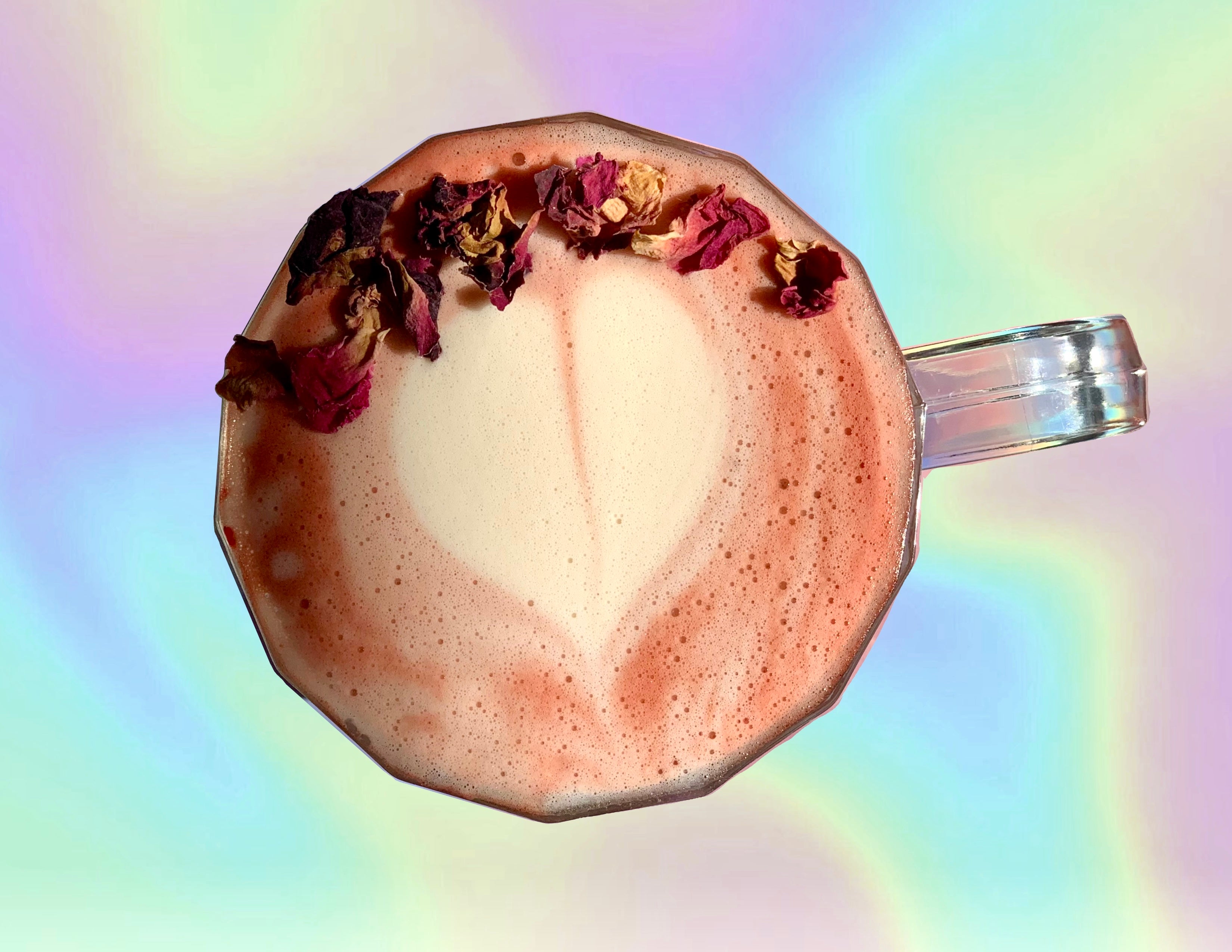 Pink latte in glass mug with latte art heart and rose petals on top, on a iridescent digital background