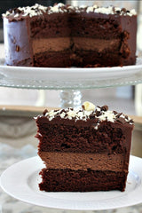 Here’s a Chocolate Cheesecake Cake that is perfect for special occasions.  It’s two layers of chocolate cake with a layer of chocolate cheesecake in the middle.  The whole cake is covered in rich chocolate frosting and sprinkled with chocolate shavings.