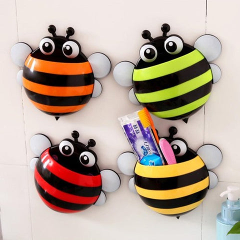 Assorted colour bee toothbrush holders on a wall. The yellow be has toothpaste and toothbrushes inside.