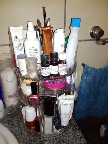 clear rotating cosmetic organiser filled with accessories