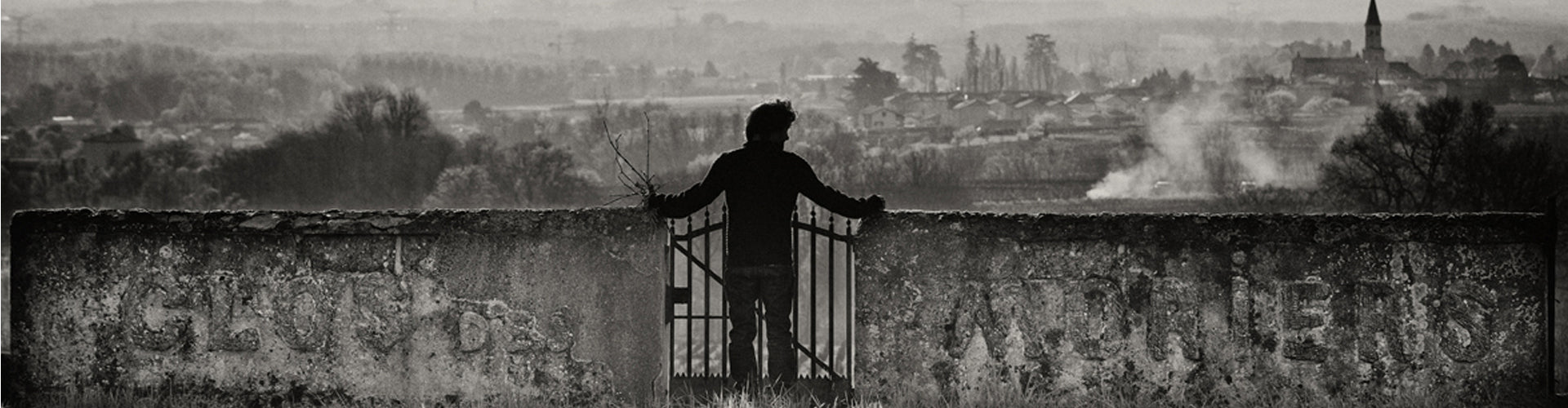 Black and White Image of Cédric Chignard looking over the Moriers lieu-dit in Fleurie