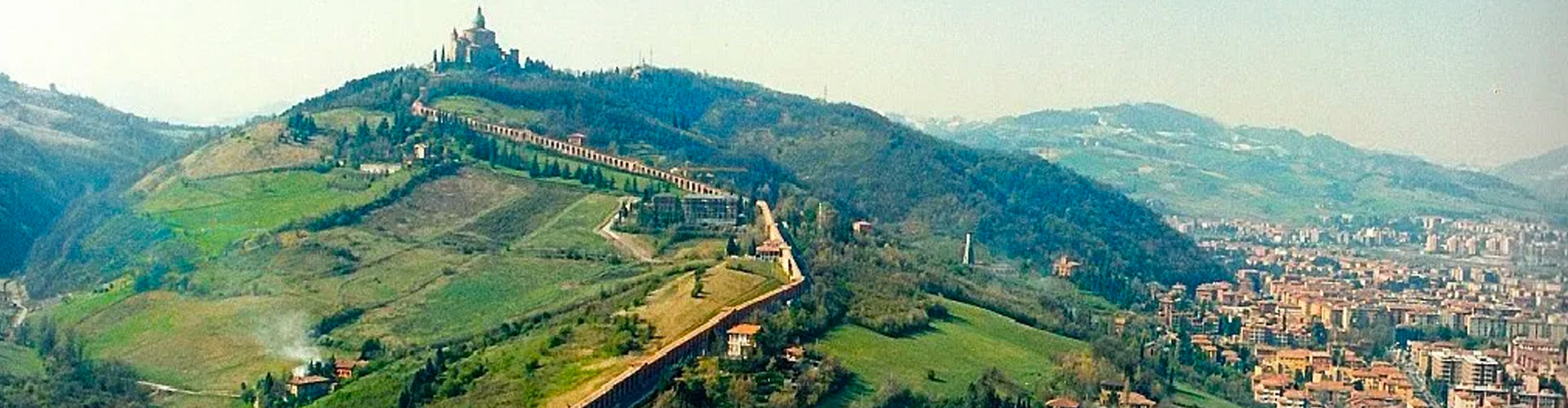A panoramic view of the hillsides of Bologna with the Portico di San Luca in the disatnce