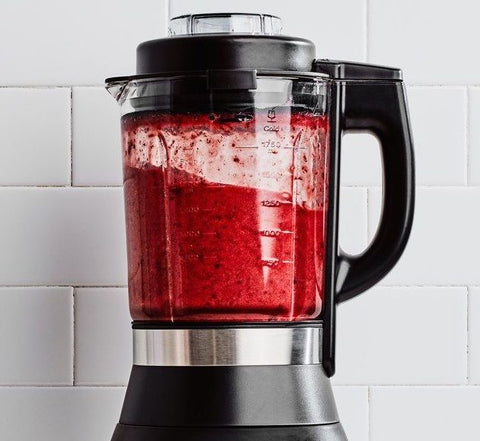 Blender containing red blended juice