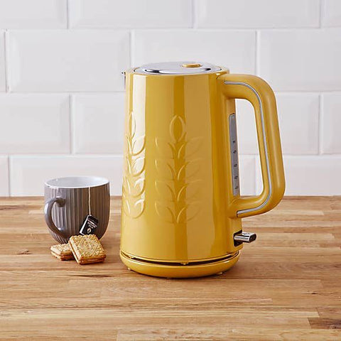 Yellow kettle and brown cup on wooden table 