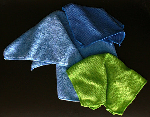 Blue and green microfiber cloths against a black background
