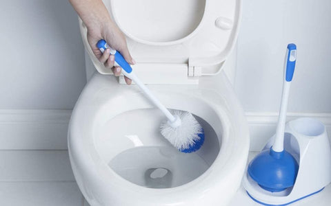 Toilet brush scrubbing the inside of a toilet bowl