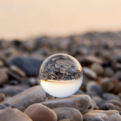 karma - glass sphere with rocks reflection