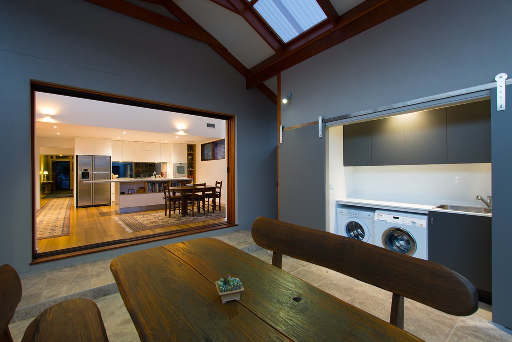 The Panama Sliding System teamed with an Aurora Timber Door cleverly conceals a laundry with character.
