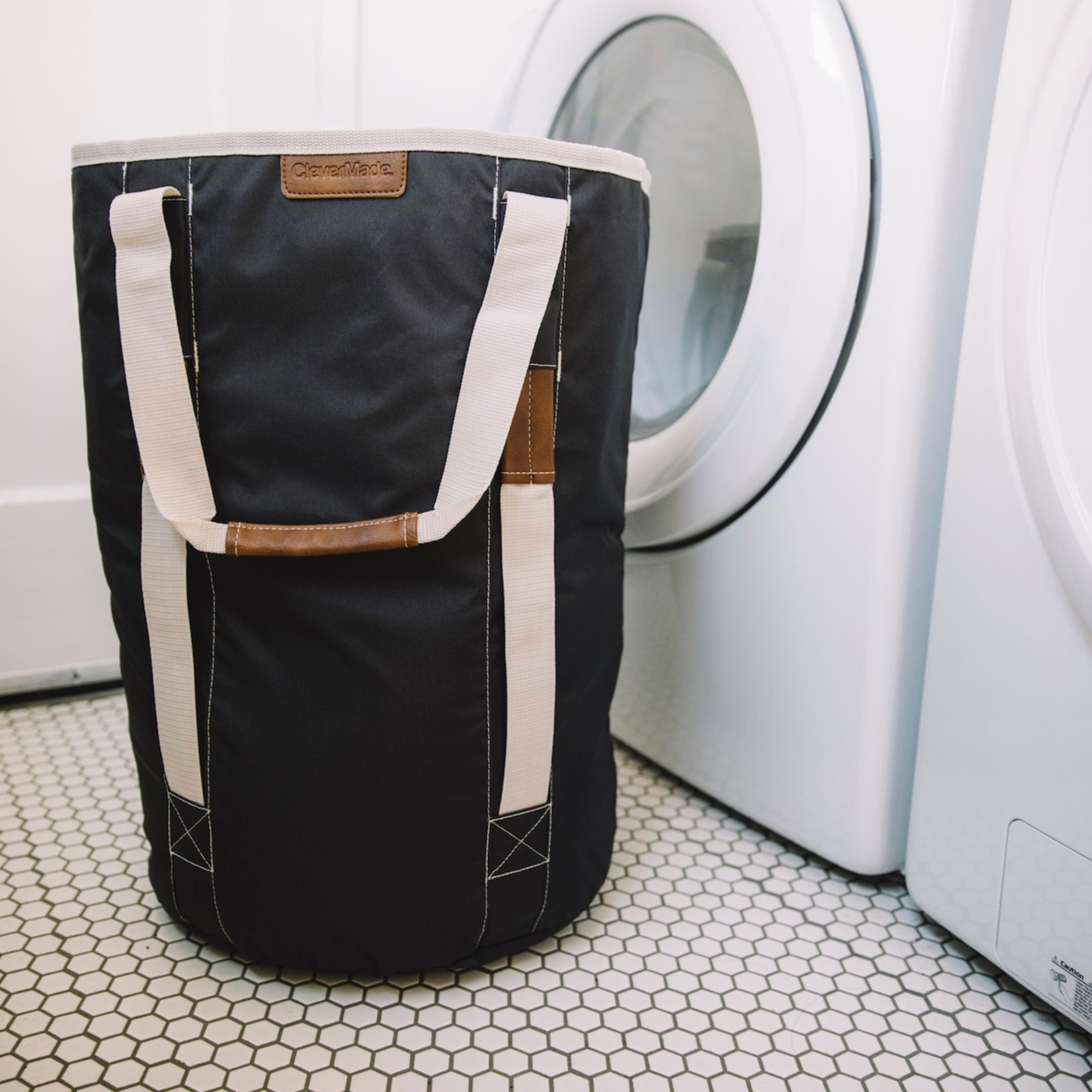 Laundry Duffel LUXE Charcoal in front of washer in laundry room