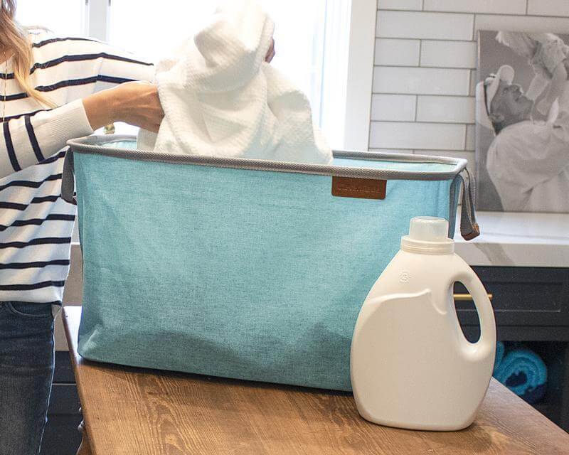 Woman sorts clothes in a Laundry Basket LUXE