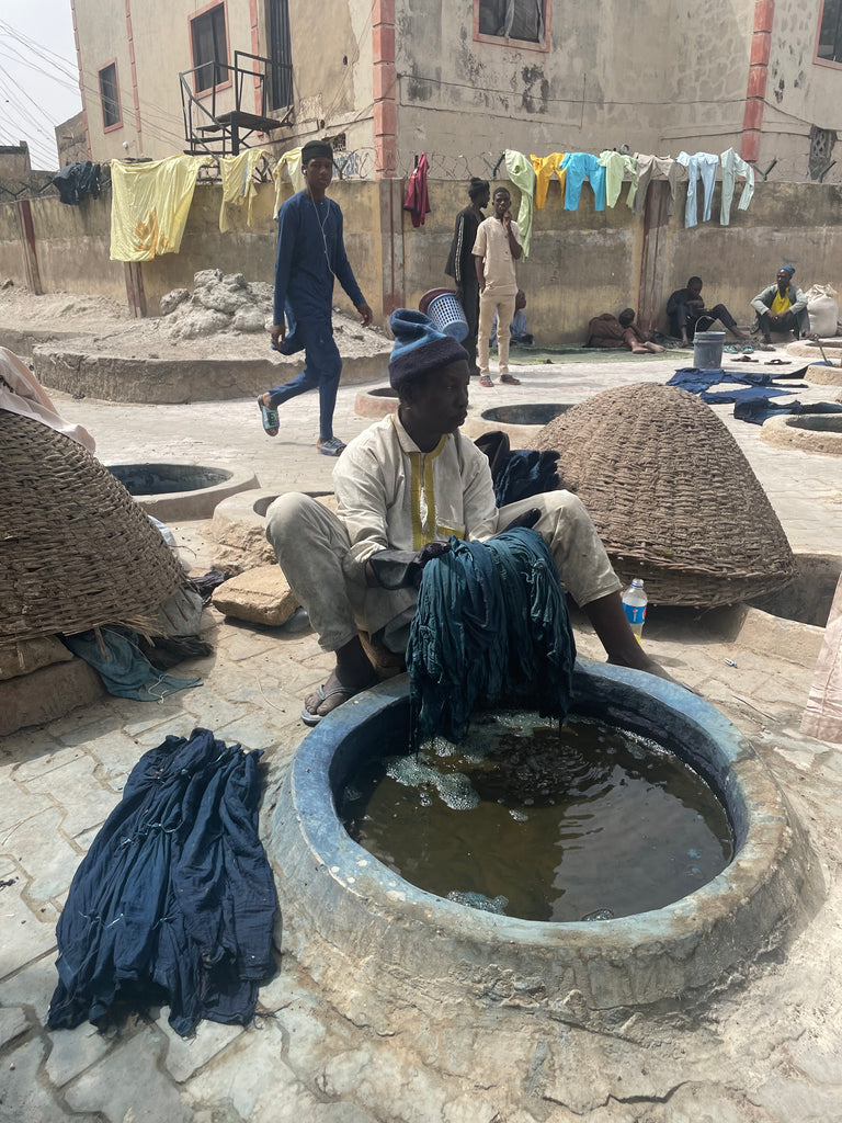 Dyer at Kofar Mata Dye Pit dying fabric.