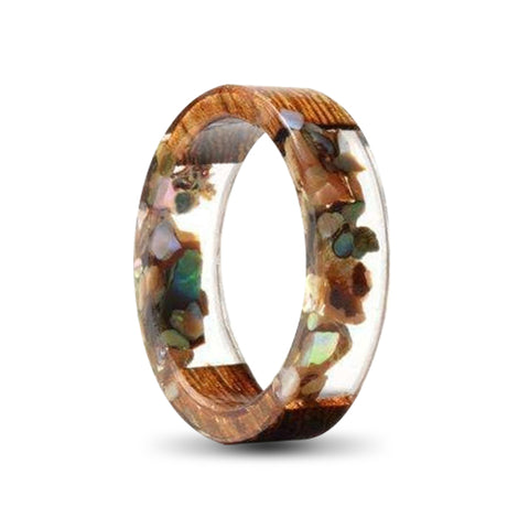 transparent resin ring with small stones and wood inlays