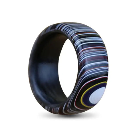 Carbon Fibre Ring with Outer Layer of Fordite on White Backdrop