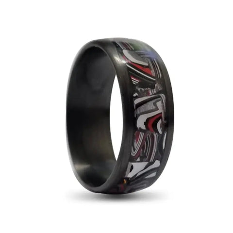 Black Carbon Fibre Ring with Fordite Layer on White Backdrop