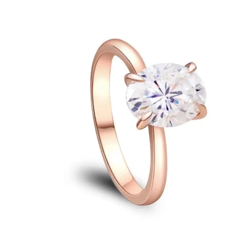 Rose Gold Moissanite Ring with Oval Cut Diamond on White Backdrop