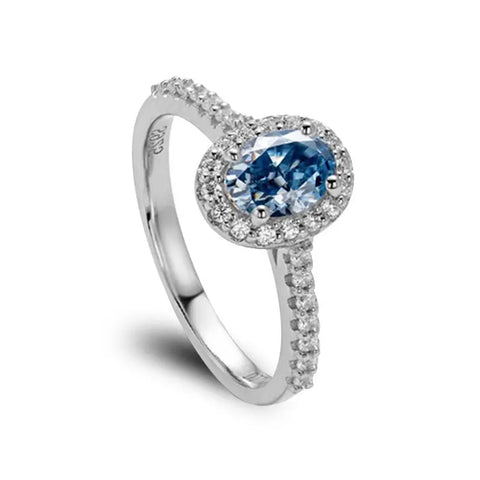 Sterling Silver Ring With Oval Cut Blue Moissanite Main Stone Surrounded by Zirconia Stones
