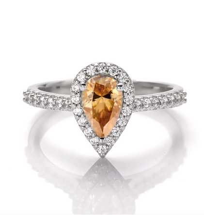 sterling silver ring with pear cut champagne colored moissanite stone surrounded by zirconia stones