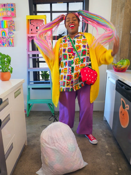 Amina looking happy in a colorful outfit.