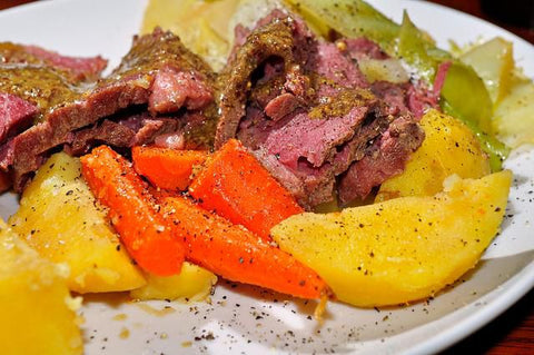 Corned beef and cabbage on dinner plate with carrots and potatoes