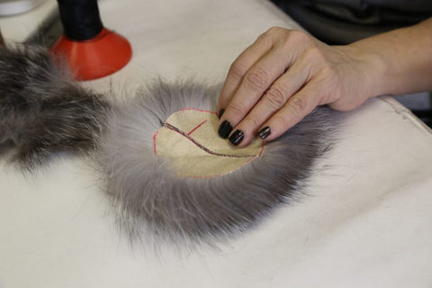 Jacqueline Ajamian selects a piece of waste fur produced during pattern cutting to make pompom for a hat at Fourrures Ajamian Ltee in Montreal, Quebec on November 28, 2021. She believes that fur is more sustainable source of warm clothes as all the parts of the animal hide are used completely hardly leaving any waste behind. Aashka Patel/Concordia