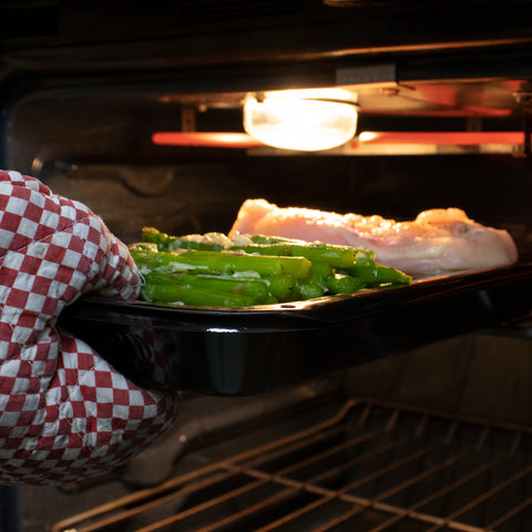 checking on food while its broiling on top of a Certified Appliance Accessories broiler pan