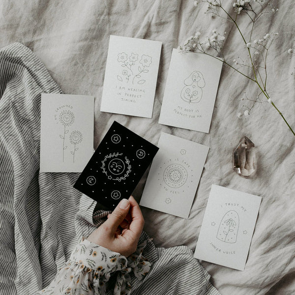 Affirmation Cards laid out on a bed to choose a card for the day