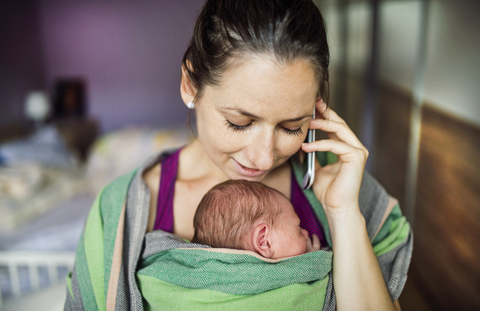 woman wearing her baby in a sling