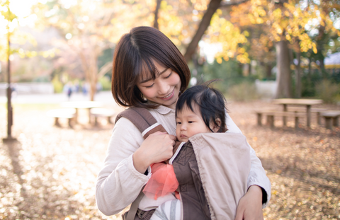 mother with her baby in a baby carrier