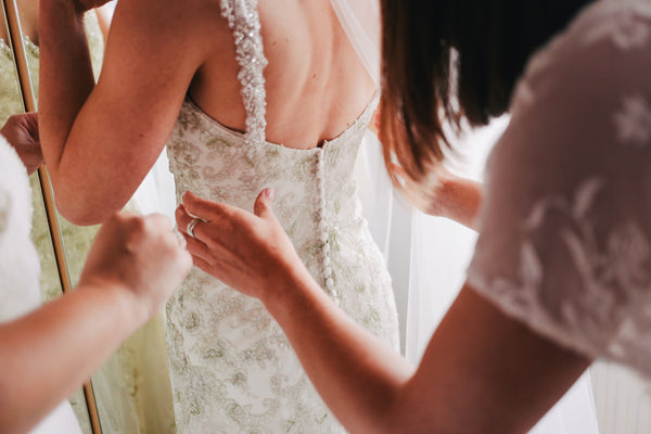 Help your bride during her wedding whenever she needs a touch up for her make up or help with her gown at the rest room. You are there for her.