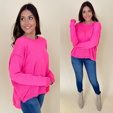 hot pink long sleeve light weight sweater with jeans and boots