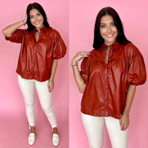 Red leather top paired with off white cream skinny jeans and loafers