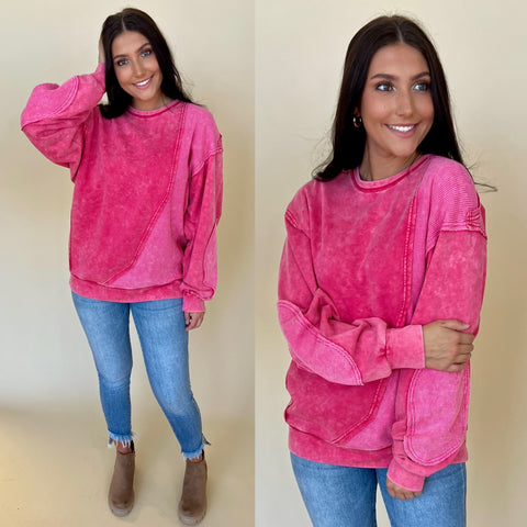 mineral washed hot pink sweatshirt with light denim jeans and boots
