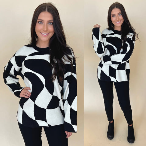 abstract swirl printed sweater in black and white paired with black jeans and black boots