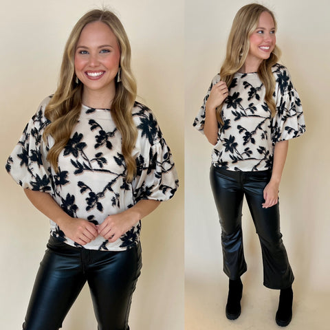 white puff sleeve floral printed top paired with black flare faux leather pants and black boots