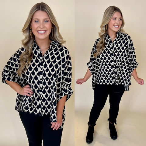 Black printed dolman sleeve button down top paired with black jeans and black boots