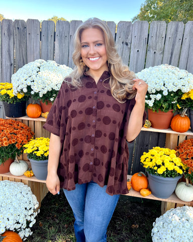 brown polka dot textured dolman sleeve button down top paired with jeans