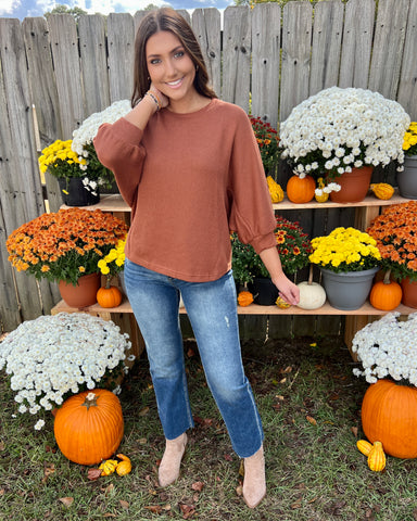 puff sleeve brown ribbed top paired with jeans and boots