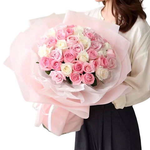 A bouquet of pink and white roses