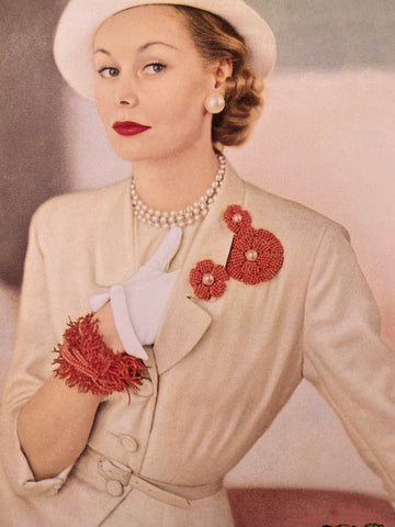 1951 photo of a model wearing Miriam Haskell coral brooches